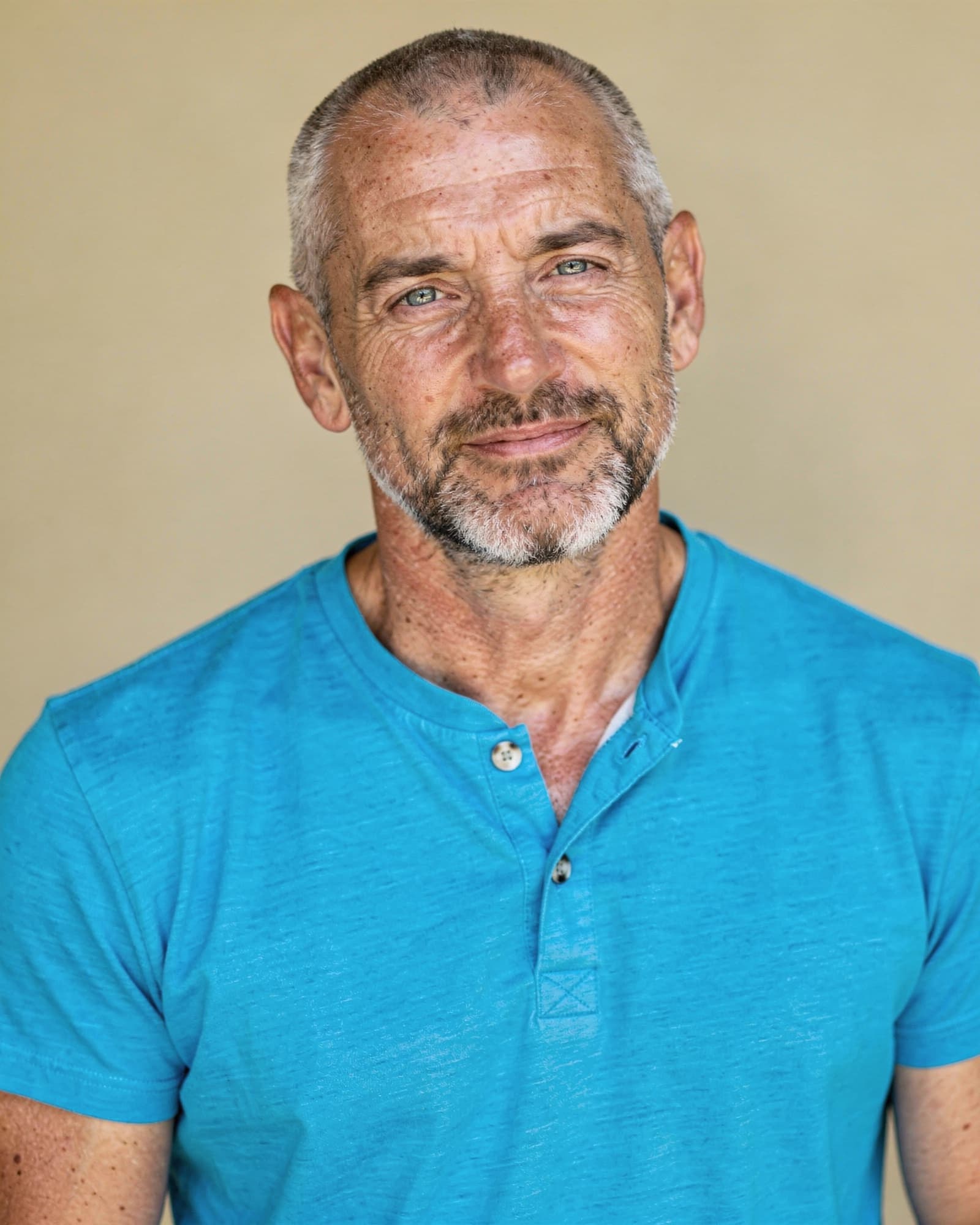A calm, approachable American man in his late forties with a few natural lines.
