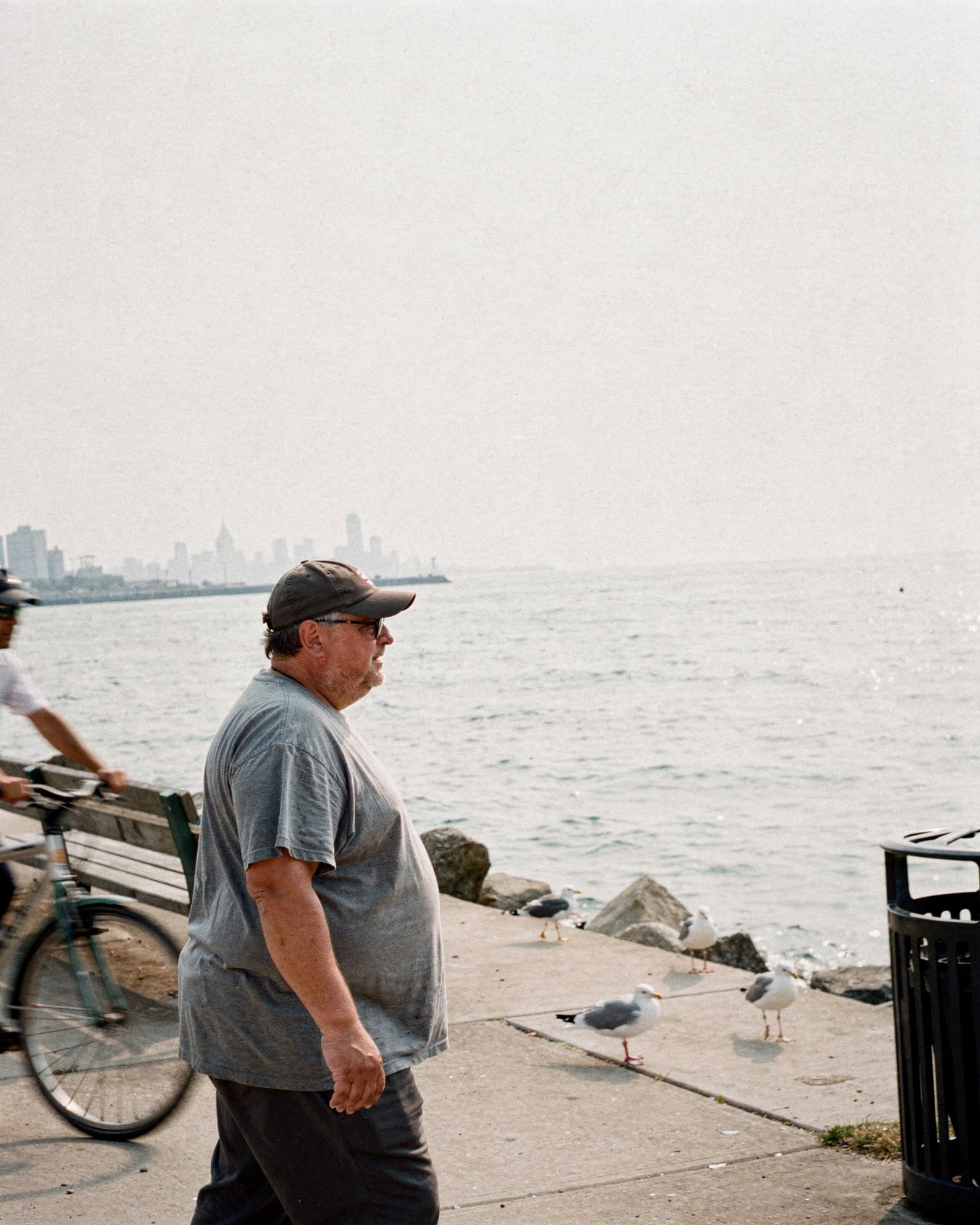 A stocky man on a morning walk along the Chicago lakefront in summer